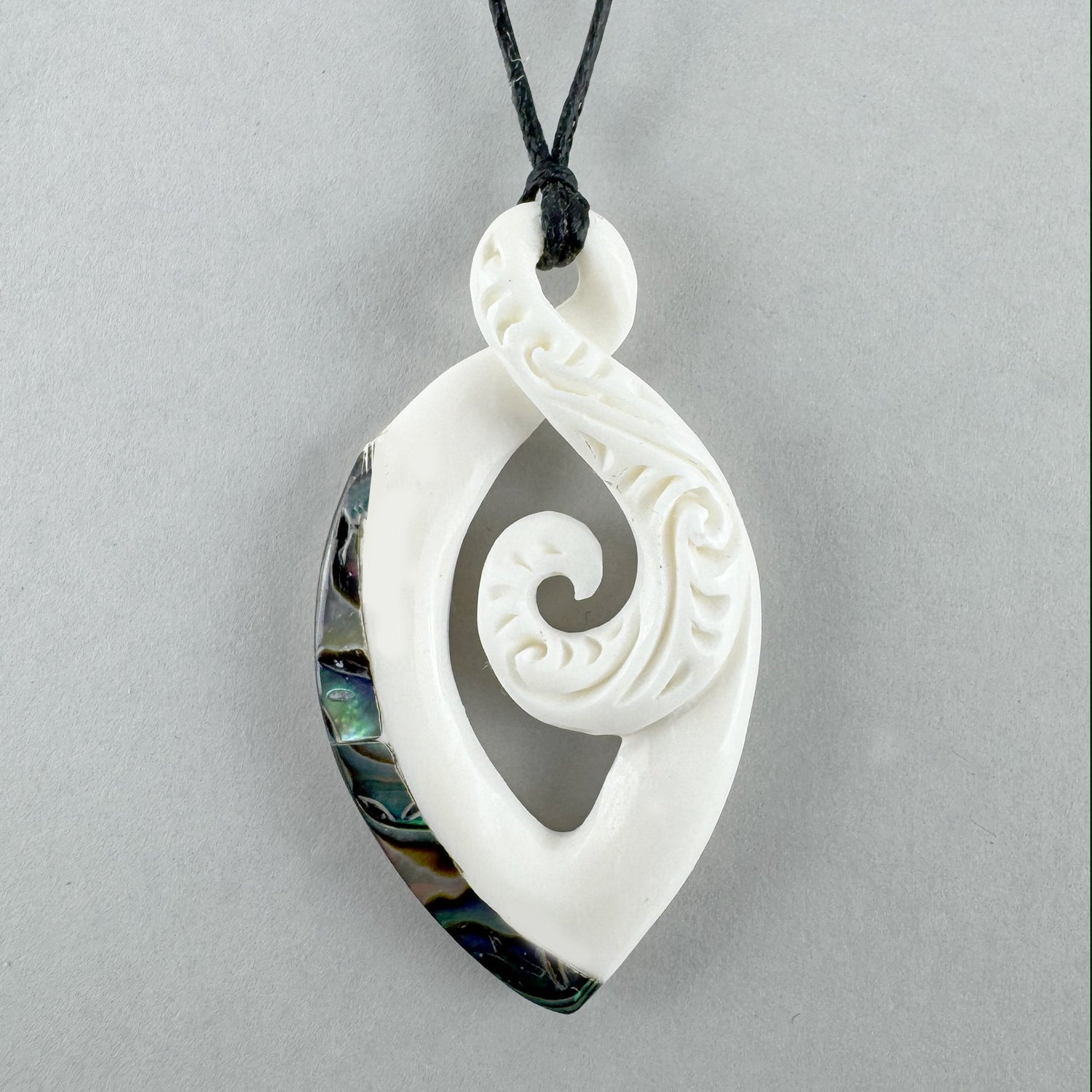 Maori Bone Twist Pendant with Inner Koru and Paua Trim - ShopNZ