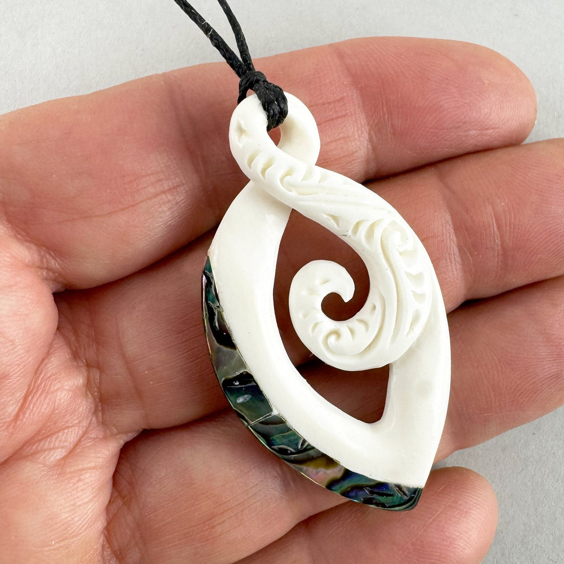 Maori Bone Twist Pendant with Inner Koru and Paua Trim - ShopNZ