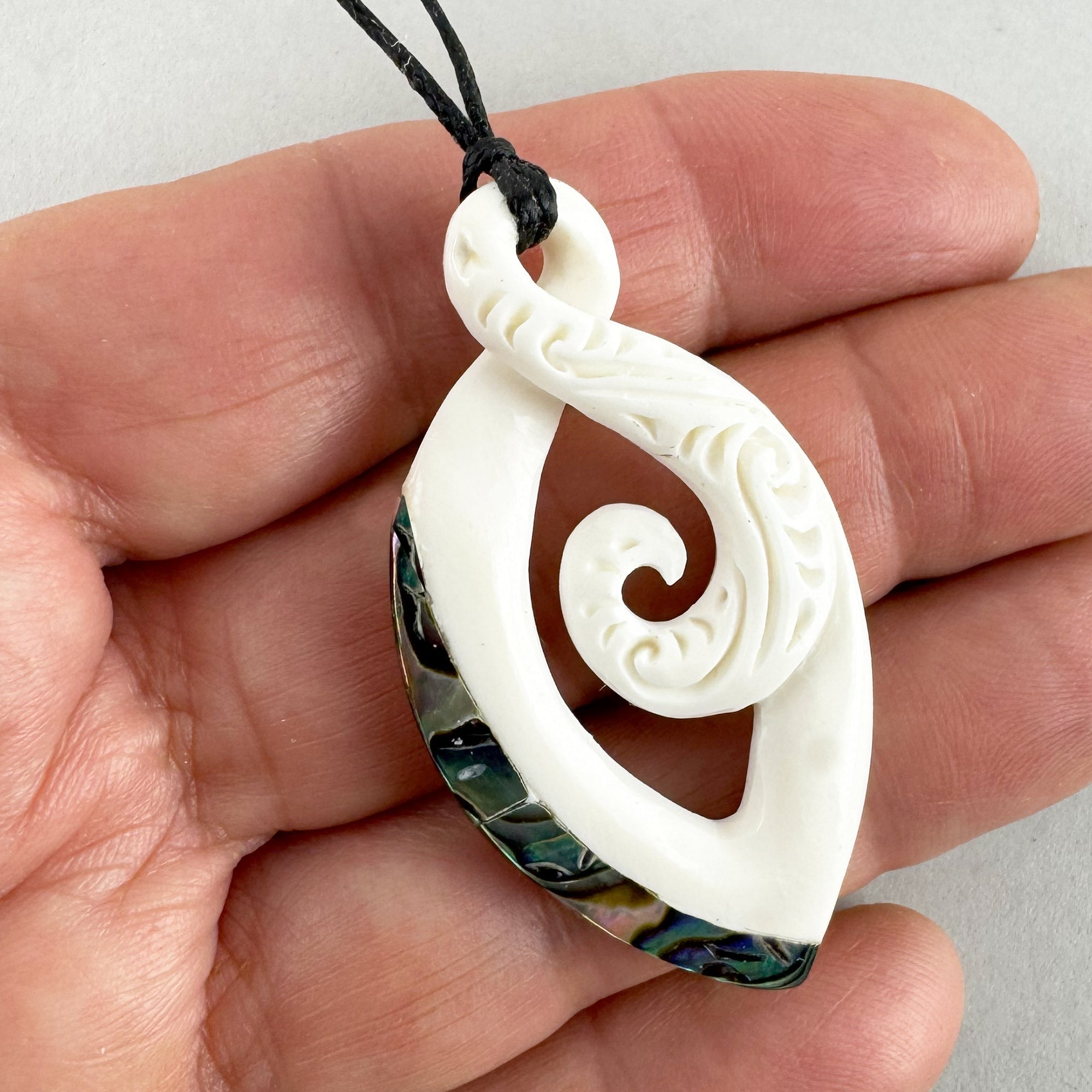 Maori Bone Twist Pendant with Inner Koru and Paua Trim - ShopNZ